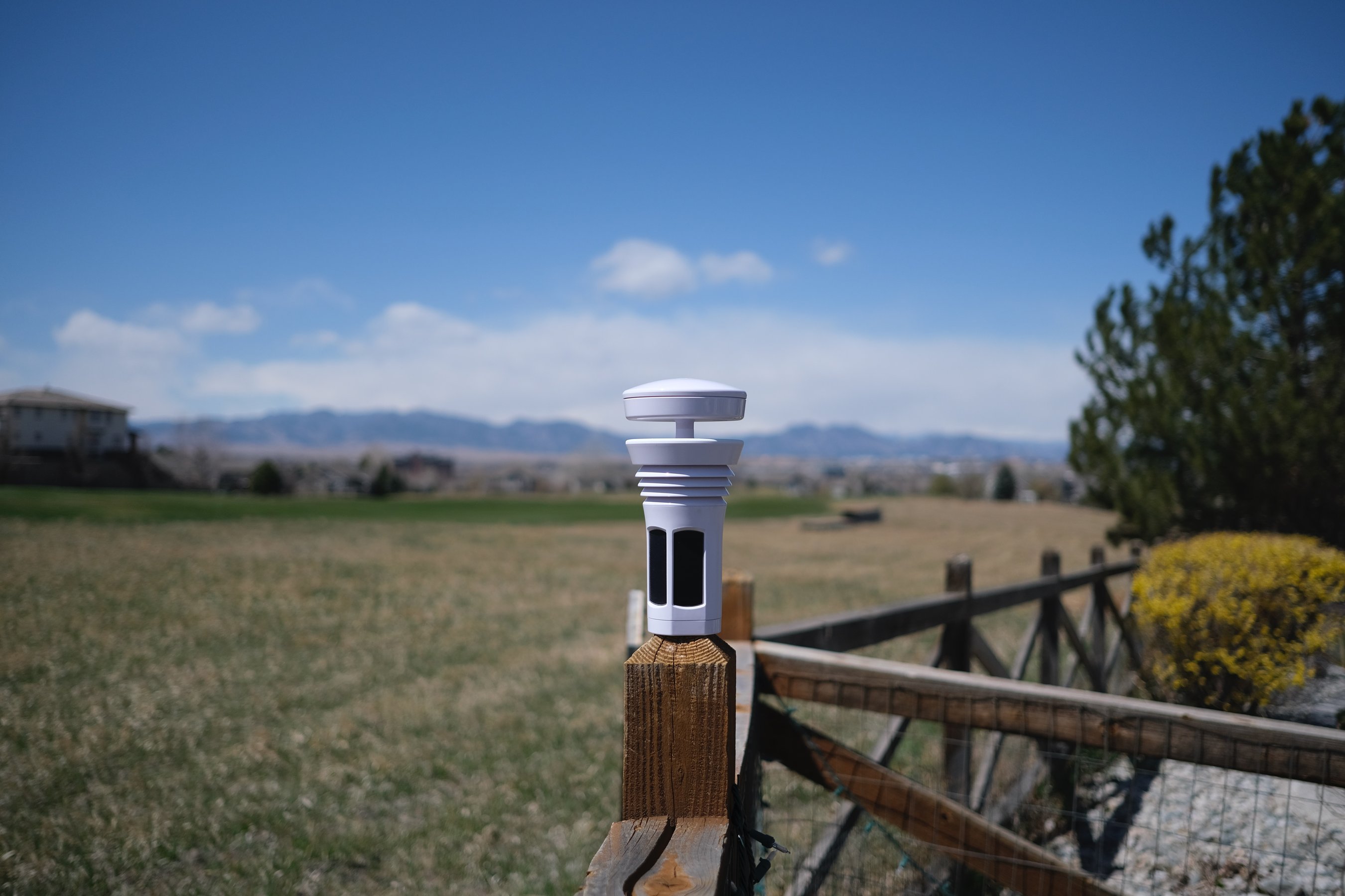 Tempest Weather Station by WeatherFlow on a fencepost